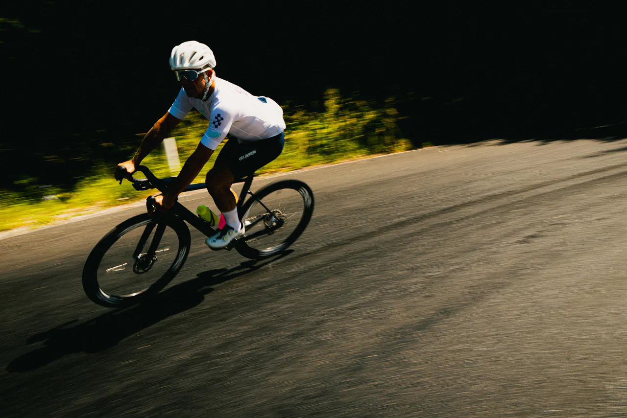 A rider descending a sunlit curve