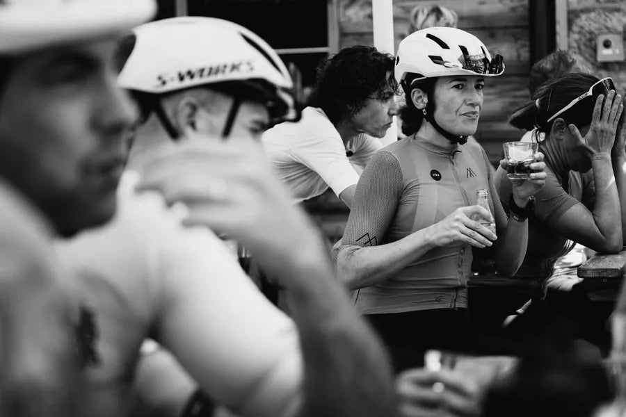 Velodrom riders laughing together at a café terrace