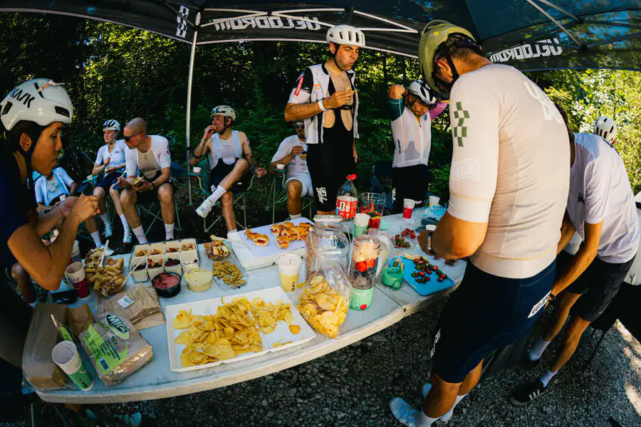 Riders at the Velodrom feed table under the team tent