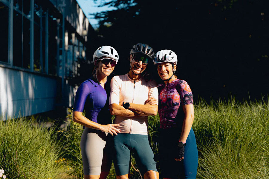 Three Velodrom riders posing arm in arm