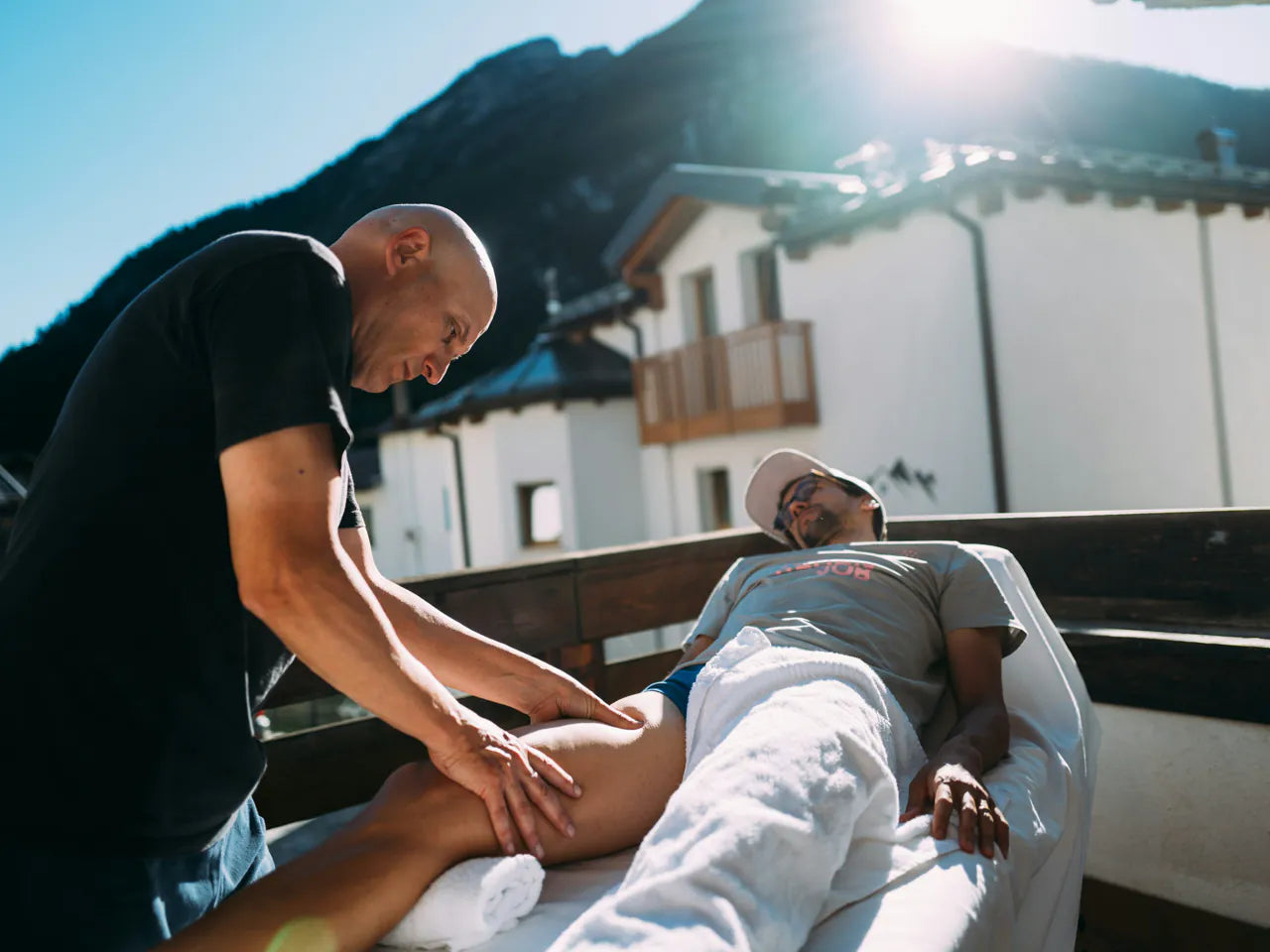 A rider getting a sports massage on a hotel terrace